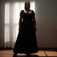 Black women wearing long dark skirts